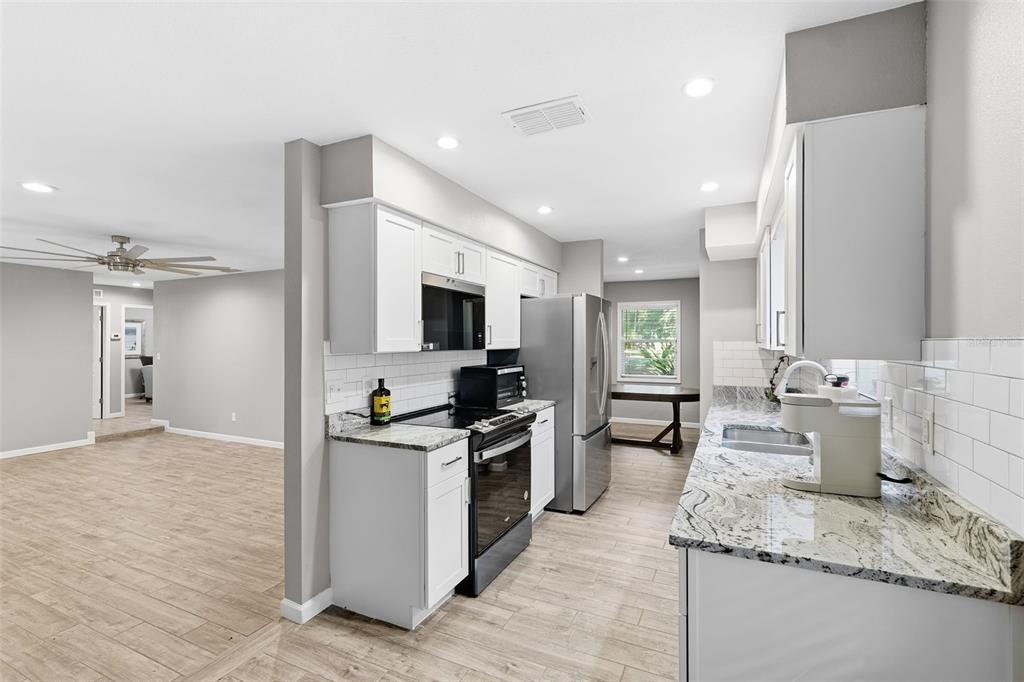 12210 State Street Tampa, FL 33635 - Photo 16 of 41 a kitchen with a sink stove and refrigerator