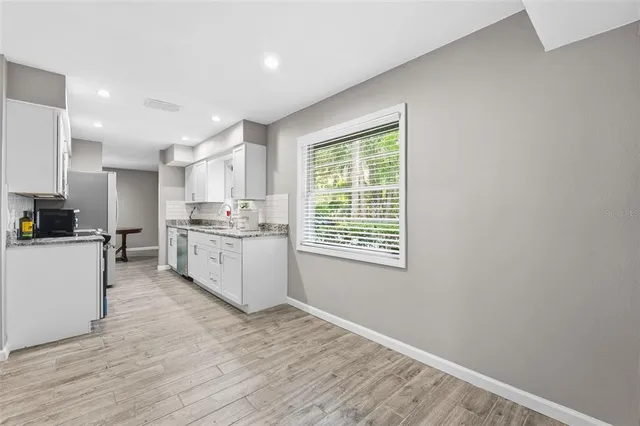 a dining room with furniture and window