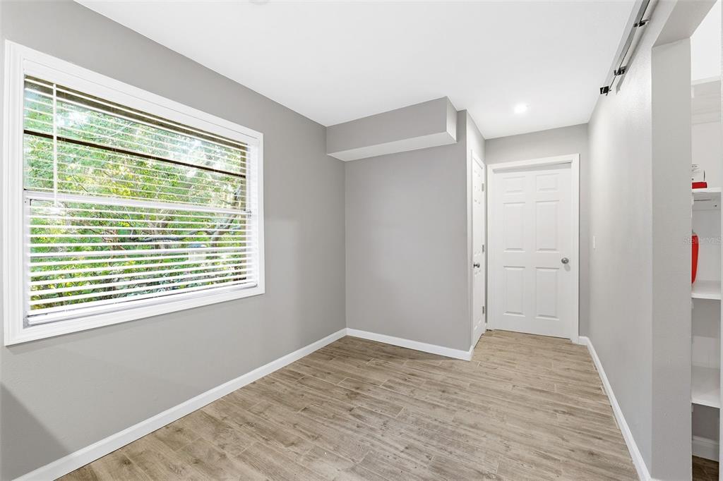 12210 State Street Tampa, FL 33635 - Photo 19 of 41 a view of an empty room with wooden floor and a window