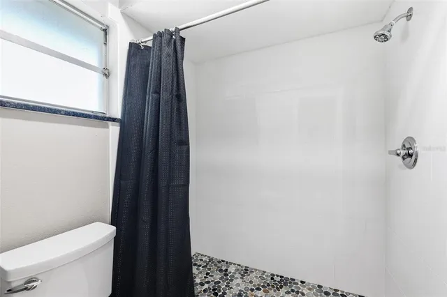 a bedroom with a bed and a potted plant