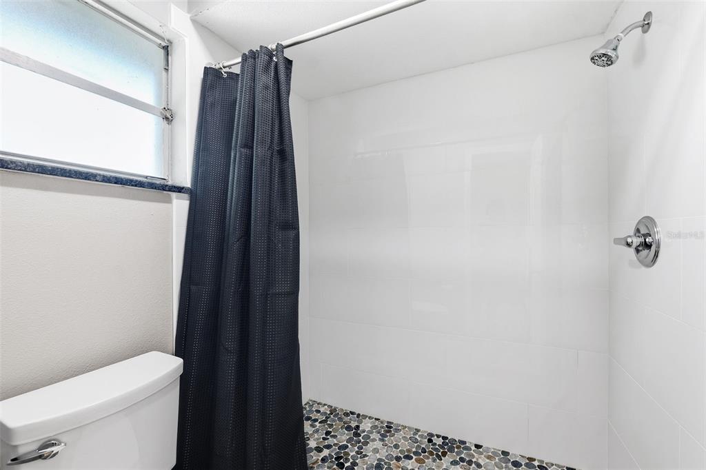 12210 State Street Tampa, FL 33635 - Photo 24 of 41 a bathroom with a shower toilet and sink