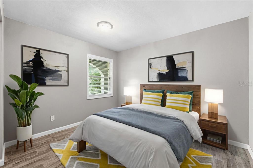 12210 State Street Tampa, FL 33635 - Photo 25 of 41 a bedroom with a bed and a potted plant