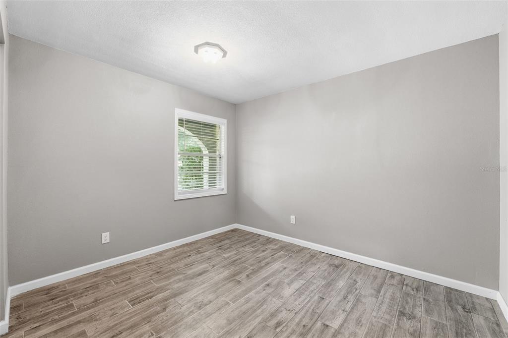 12210 State Street Tampa, FL 33635 - Photo 26 of 41 wooden floor in an empty room with a window