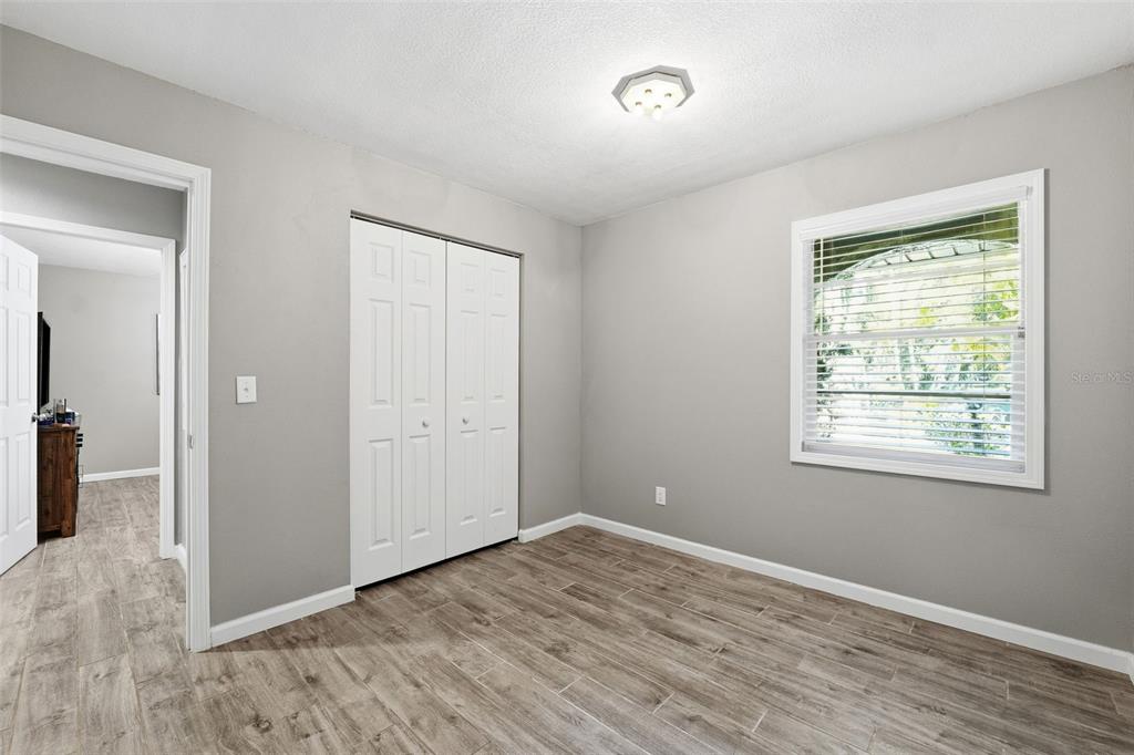 12210 State Street Tampa, FL 33635 - Photo 28 of 41 a view of an empty room with wooden floor and a window
