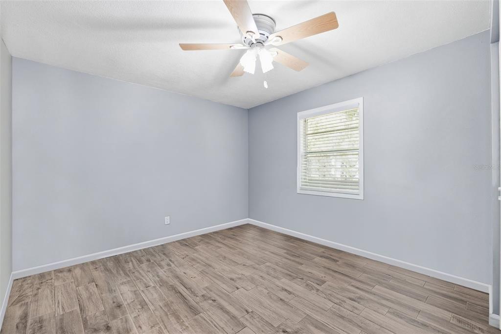 12210 State Street Tampa, FL 33635 - Photo 29 of 41 wooden floor in an empty room with a window