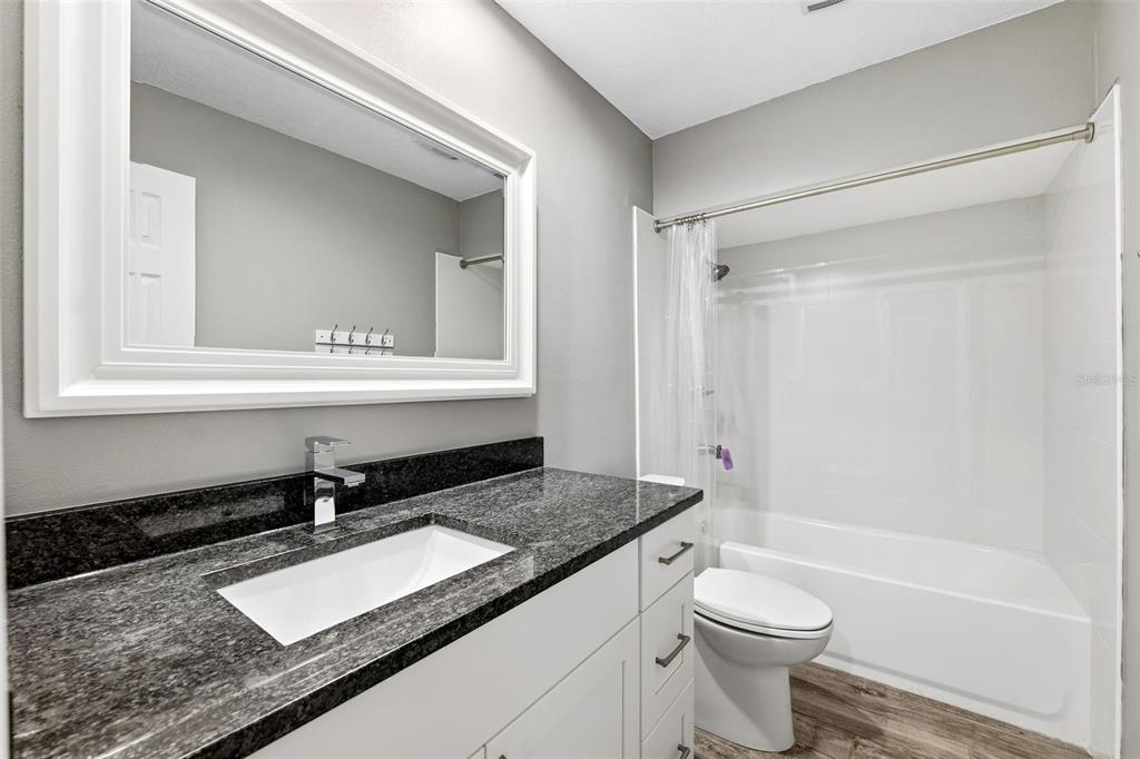 12210 State Street Tampa, FL 33635 - Photo 31 of 41 a bathroom with a granite countertop sink and a mirror