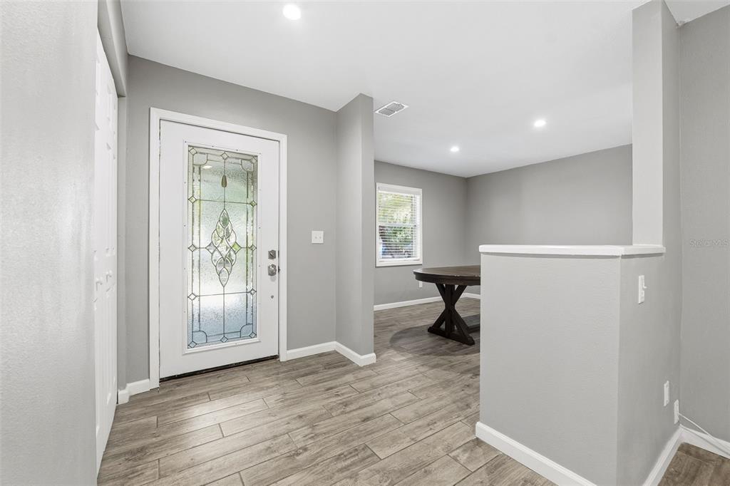 12210 State Street Tampa, FL 33635 - Photo 5 of 41 a view of an empty room with wooden floor and a window