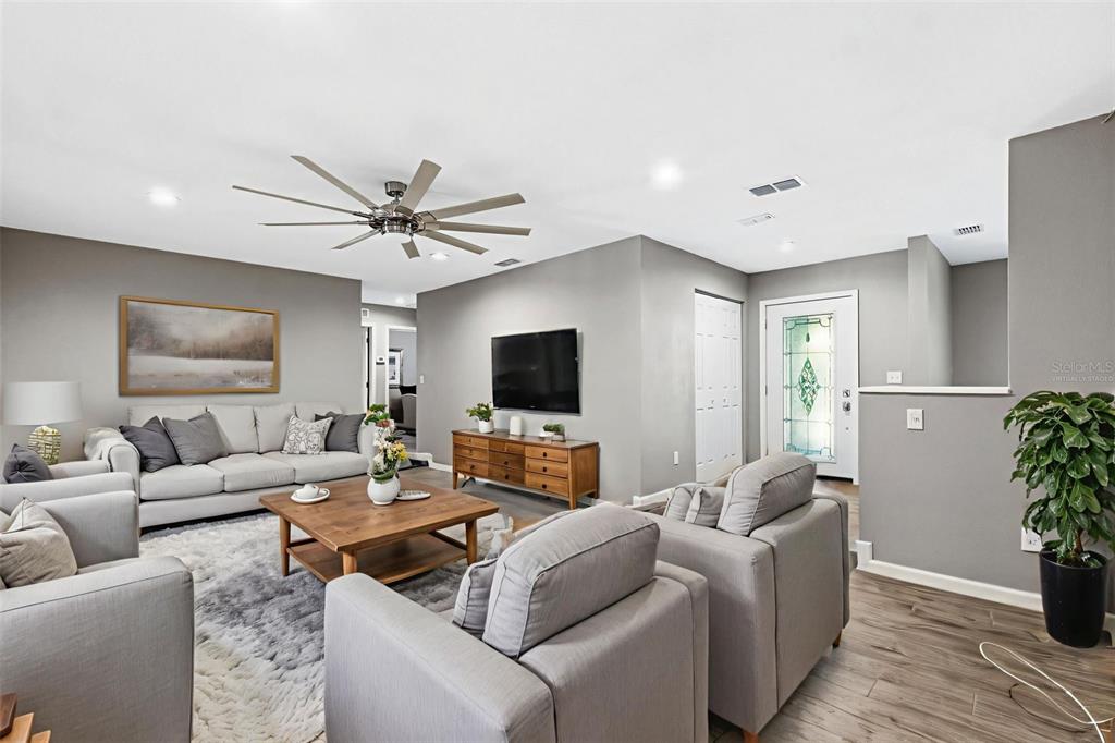 12210 State Street Tampa, FL 33635 - Photo 6 of 41 a living room with furniture and a flat screen tv