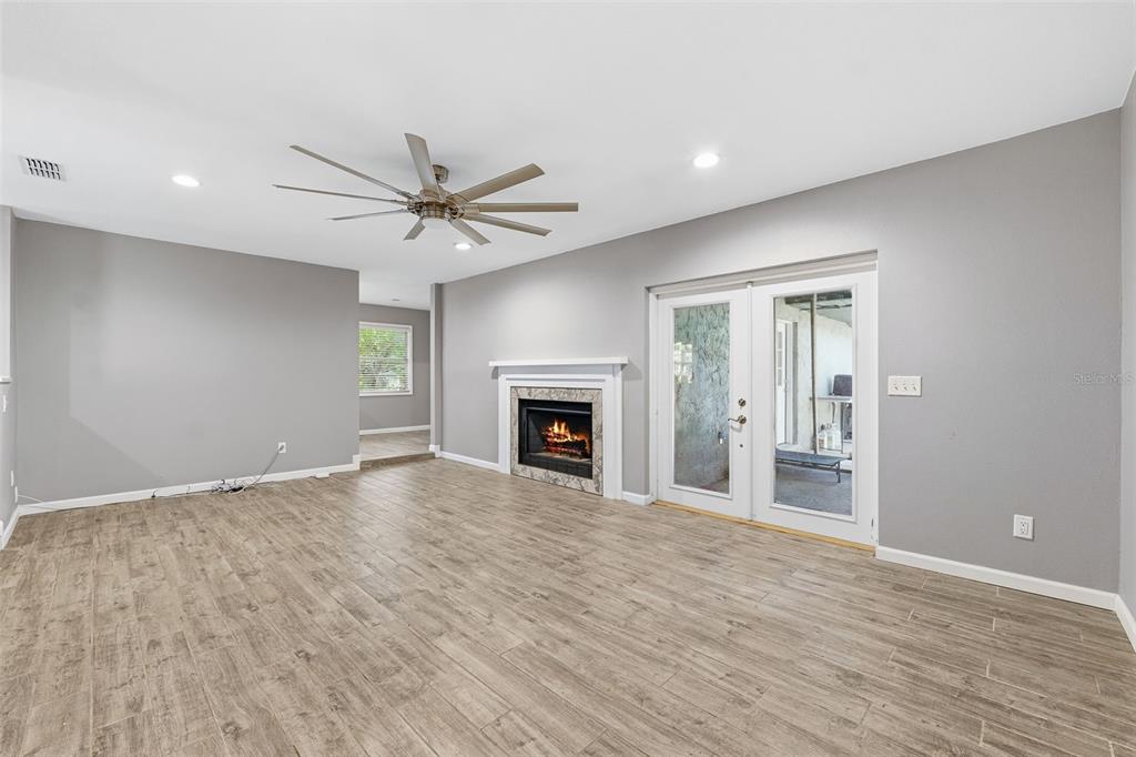 12210 State Street Tampa, FL 33635 - Photo 7 of 41 a view of an empty room with a fireplace and a window