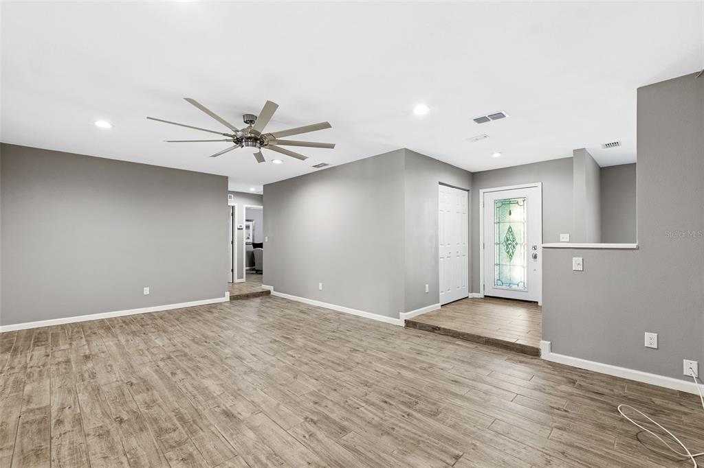12210 State Street Tampa, FL 33635 - Photo 10 of 41 an empty room with wooden floor and ceiling fan