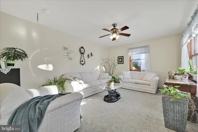a view of a livingroom with furniture and a workspace