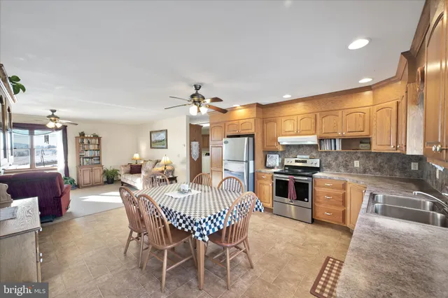 a living room with furniture gym equipment and a large window