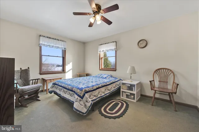 a view of a livingroom with workspace and a window