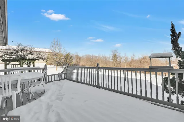 a bedroom with two beds and a chair