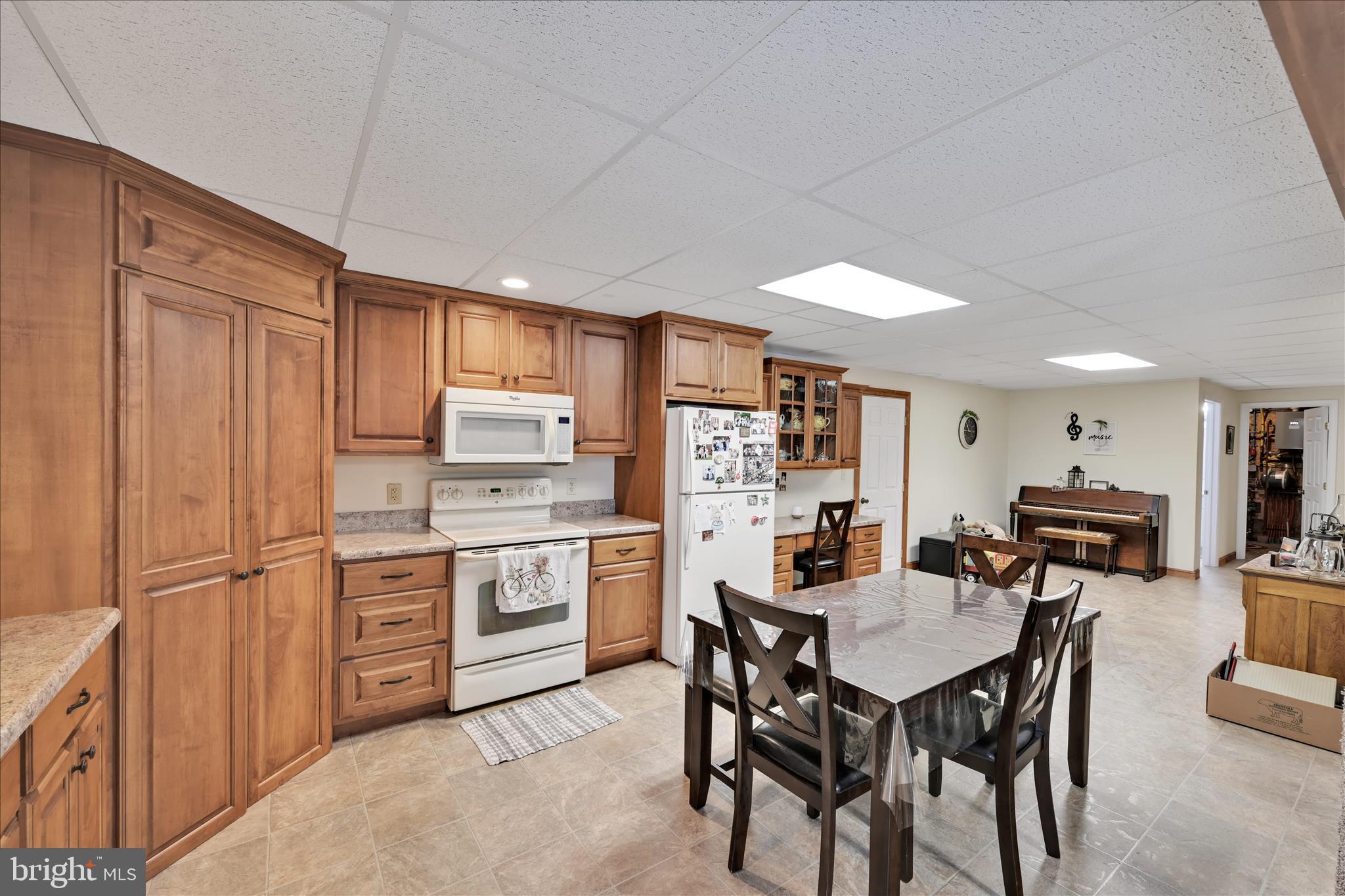 36 Host Road Womelsdorf, PA 19567 - Photo 37 of 78 a kitchen with refrigerator cabinets dining table and chairs