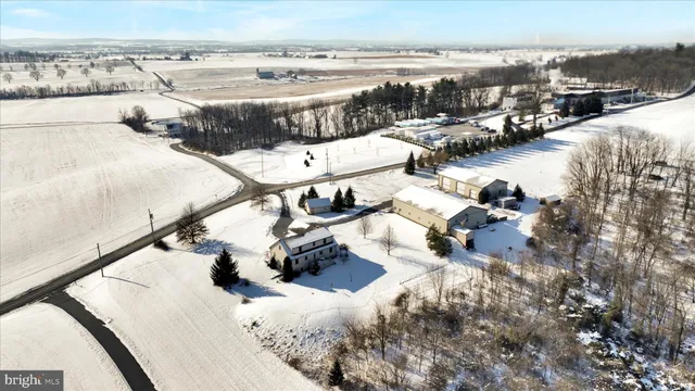 a view of house with yard and car parked