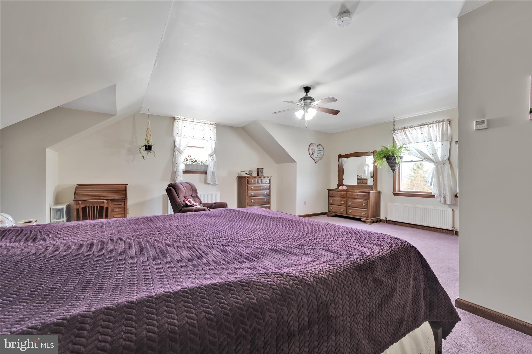 36 Host Road Womelsdorf, PA 19567 - Photo 45 of 78 a spacious bedroom with a large bed a chandelier and dresser