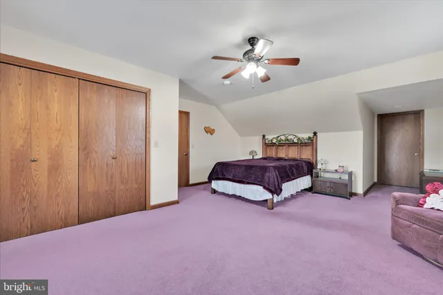 a bedroom with furniture and a book shelf