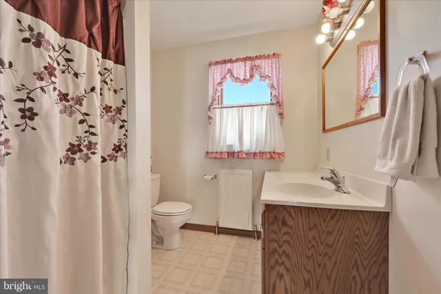 a view of road with card parked on side and road