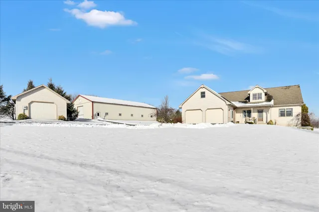 a view of a white house with a street