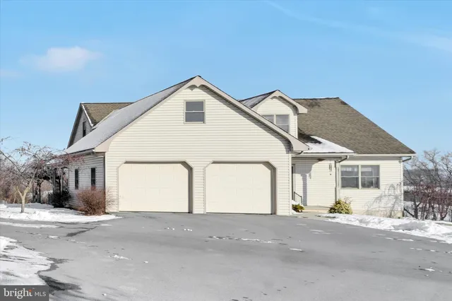 a view of a house with a snow in the background