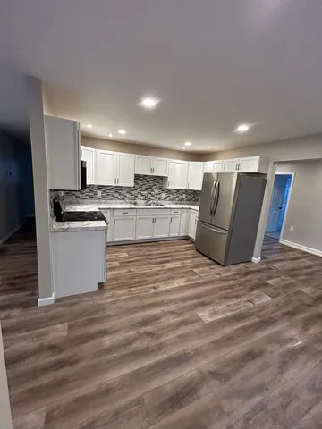 a kitchen with stainless steel appliances granite countertop a stove and a refrigerator