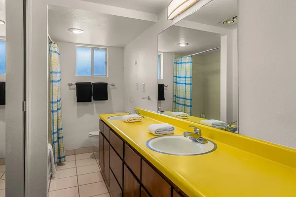 a bathroom with a granite countertop sink and a mirror