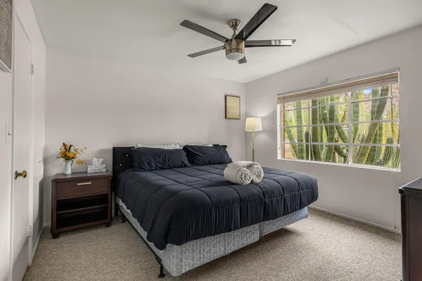 a bedroom with a bed and a window