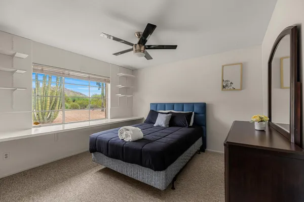a bedroom with a bed and a large window