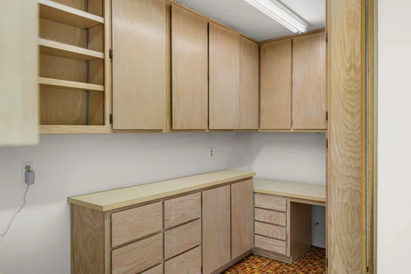 a kitchen with white cabinets and sink
