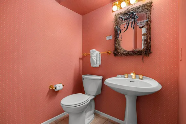 a bathroom with a sink mirror and toilet