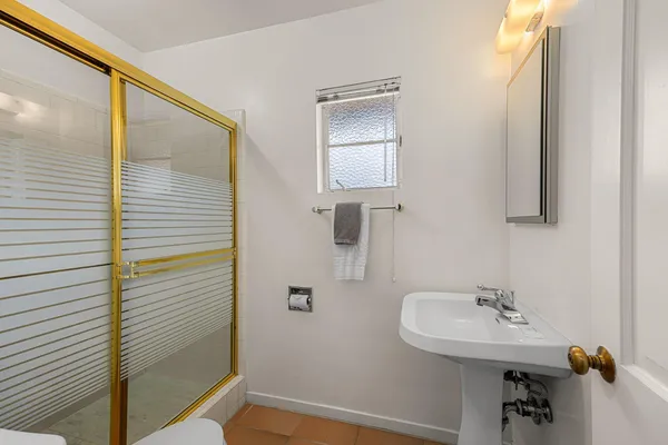 a bathroom with a sink a mirror and a shower
