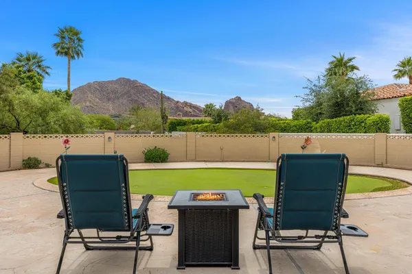 a view of a chairs and table in the patio