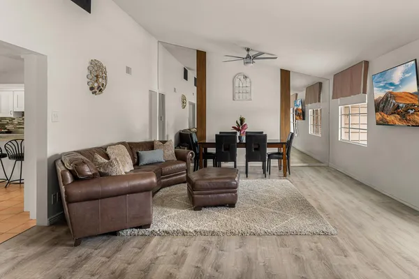 a living room with furniture and wooden floor