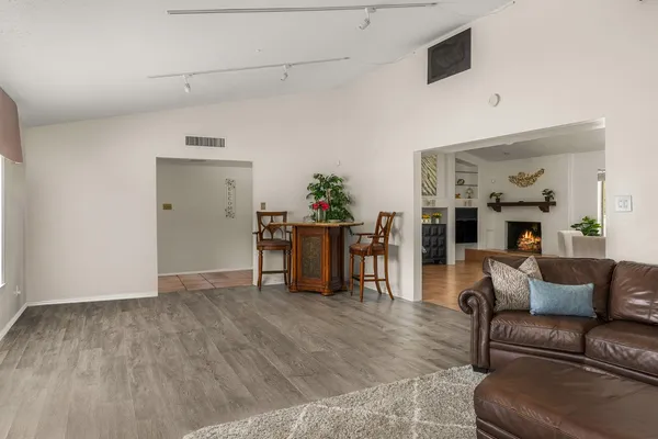 a living room with furniture and wooden floor