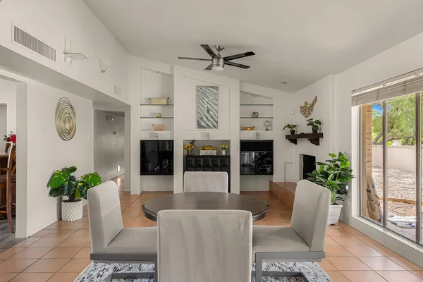 a living room with furniture potted plant and a window