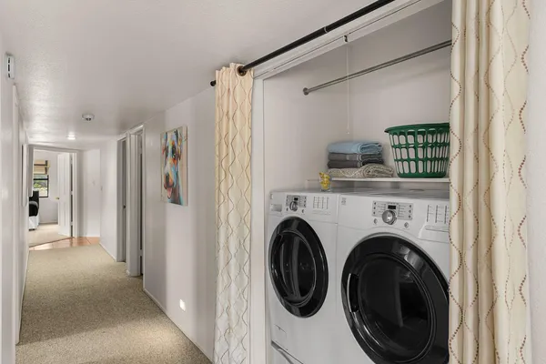 a view of a hallway with washer and dryer