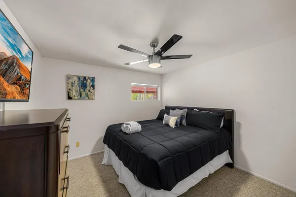 a bedroom with a bed and a desk