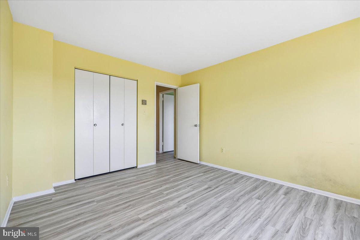 1111 University Boulevard West, Unit 1106A Silver Spring, MD 20902 - Photo 18 of 35 a view of an empty room with wooden floor