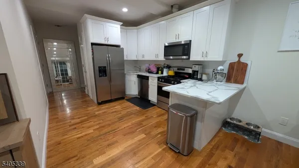 a kitchen with a refrigerator microwave and sink