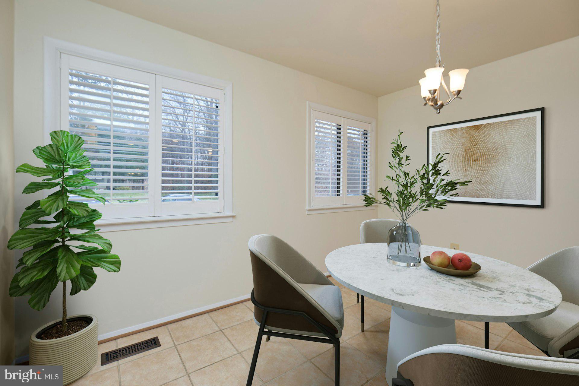 8566 Gwynedd Way Springfield, VA 22153 - Photo 11 of 61 a dining room with furniture and potted plants