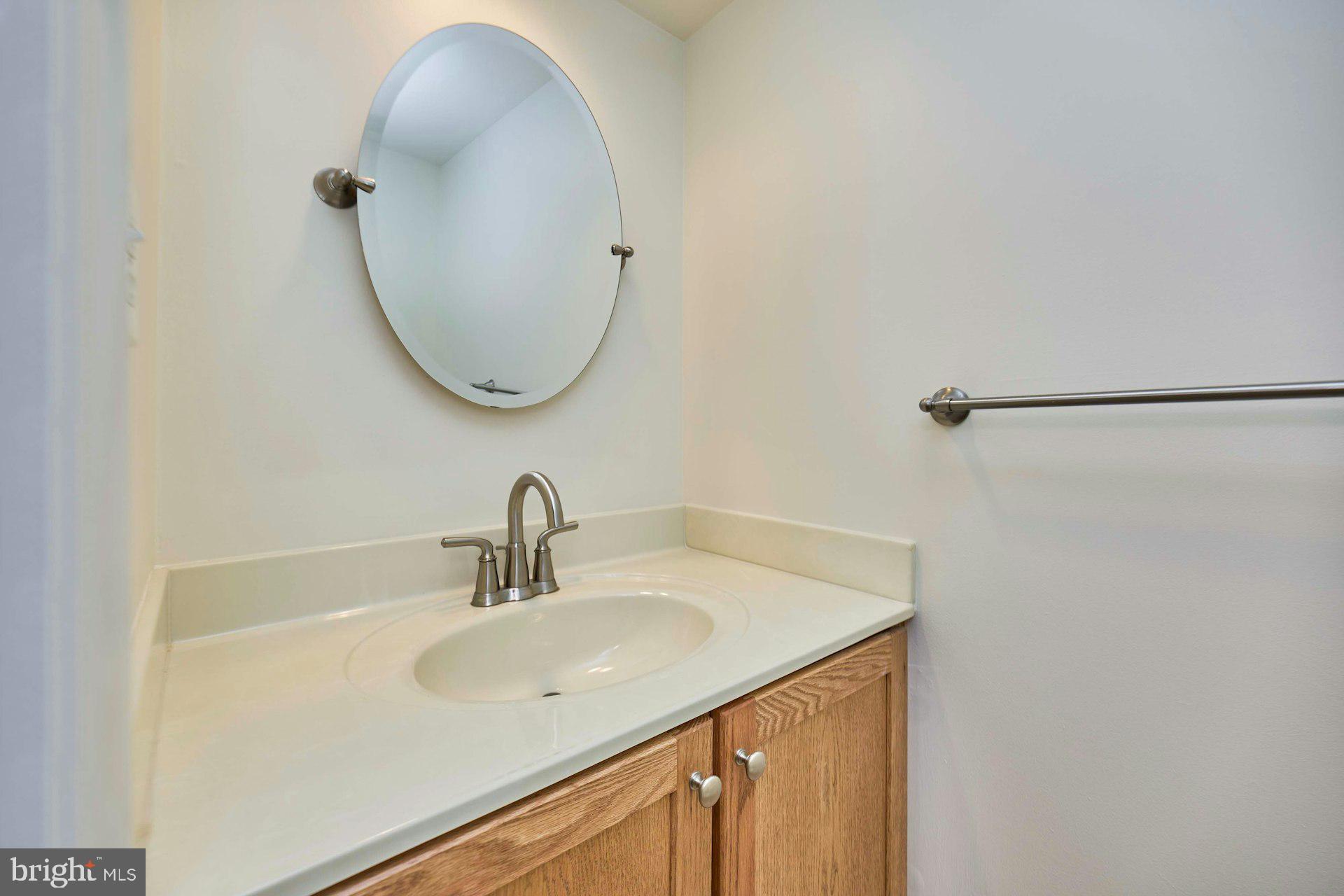 8566 Gwynedd Way Springfield, VA 22153 - Photo 13 of 61 a bathroom with a sink and a mirror
