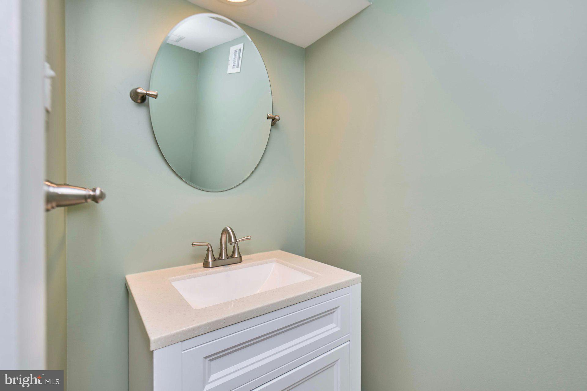 8566 Gwynedd Way Springfield, VA 22153 - Photo 28 of 61 a bathroom with a sink and mirror