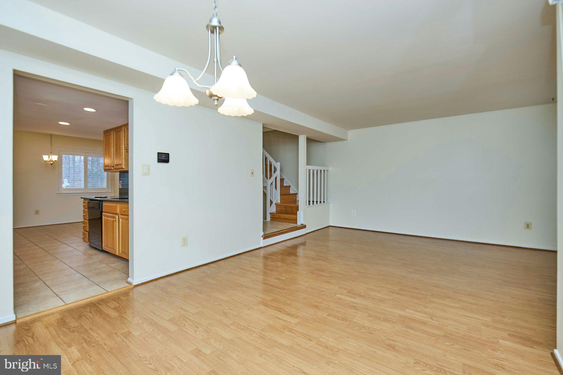 8566 Gwynedd Way Springfield, VA 22153 - Photo 33 of 61 a view of a livingroom with a chandelier fan