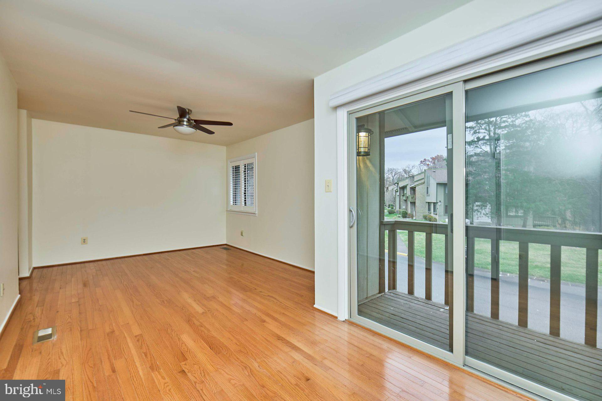 8566 Gwynedd Way Springfield, VA 22153 - Photo 38 of 61 a view of empty room with wooden floor and fan