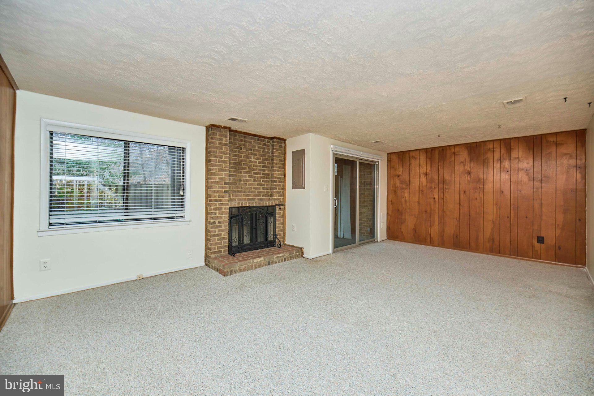 8566 Gwynedd Way Springfield, VA 22153 - Photo 46 of 61 a view of an empty room with a fireplace and a window