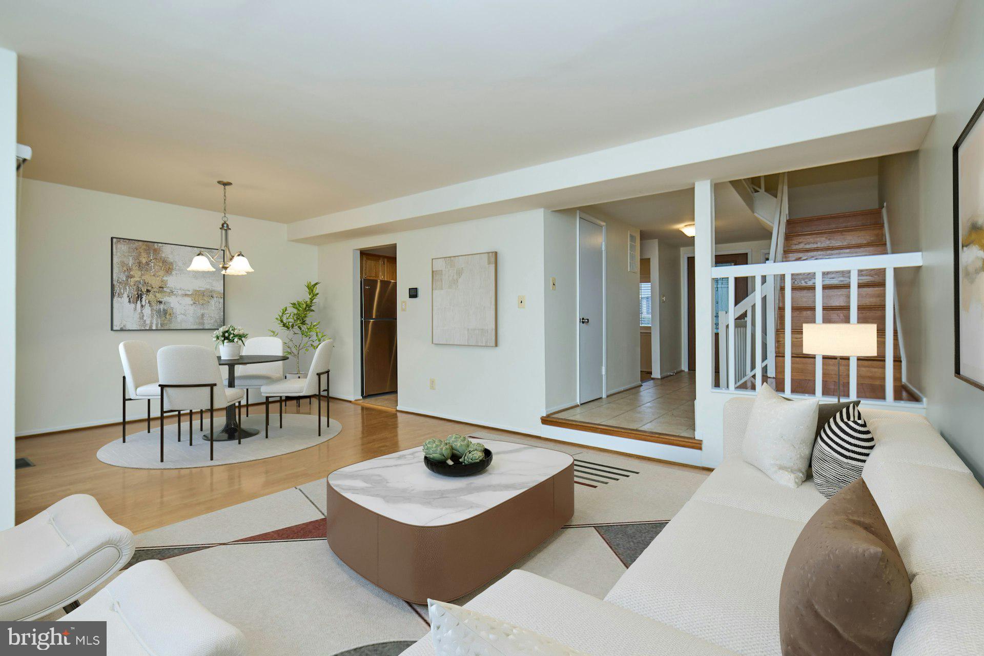 8566 Gwynedd Way Springfield, VA 22153 - Photo 6 of 61 a living room with furniture and view of kitchen