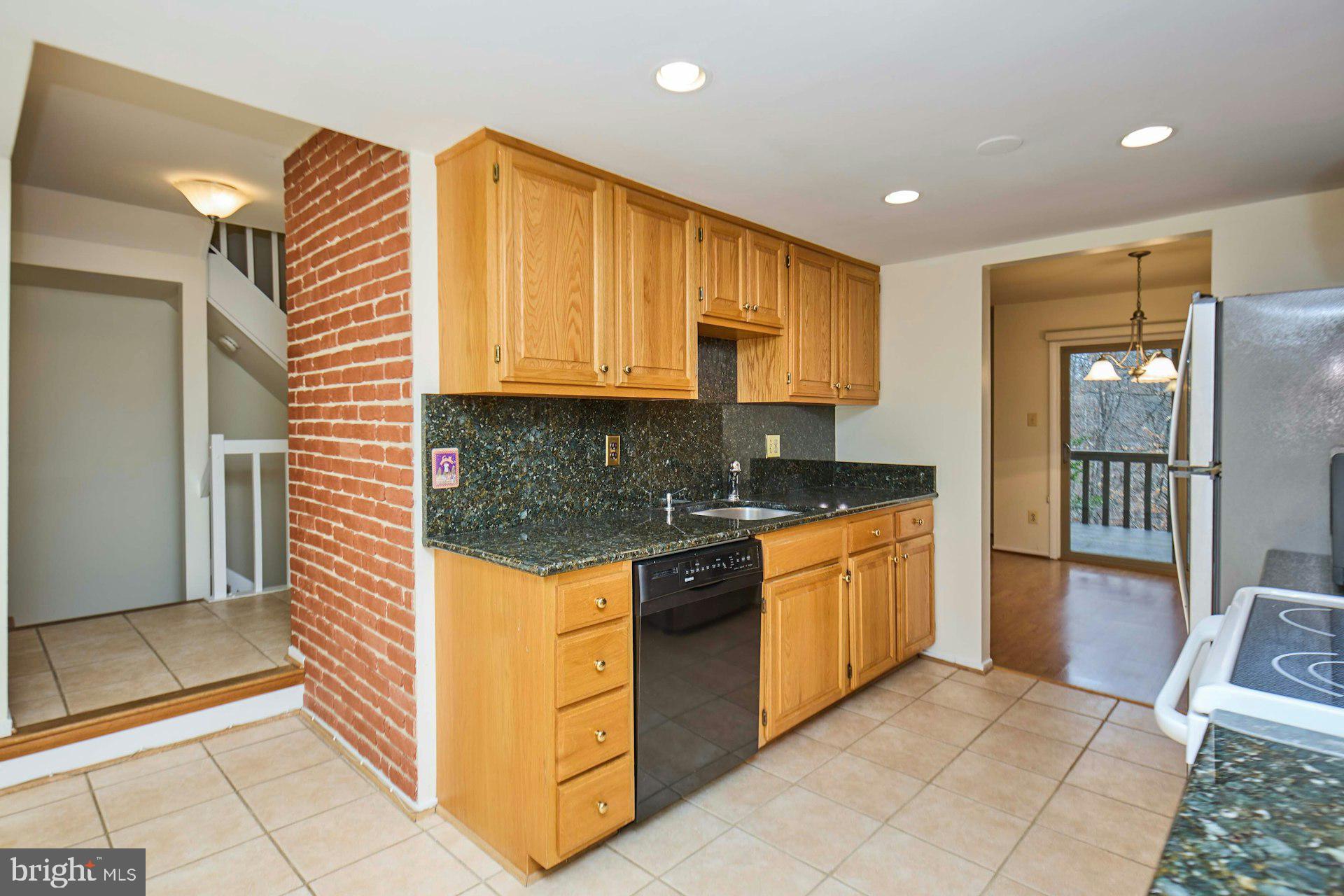 8566 Gwynedd Way Springfield, VA 22153 - Photo 9 of 61 a kitchen with stainless steel appliances granite countertop a refrigerator and a sink