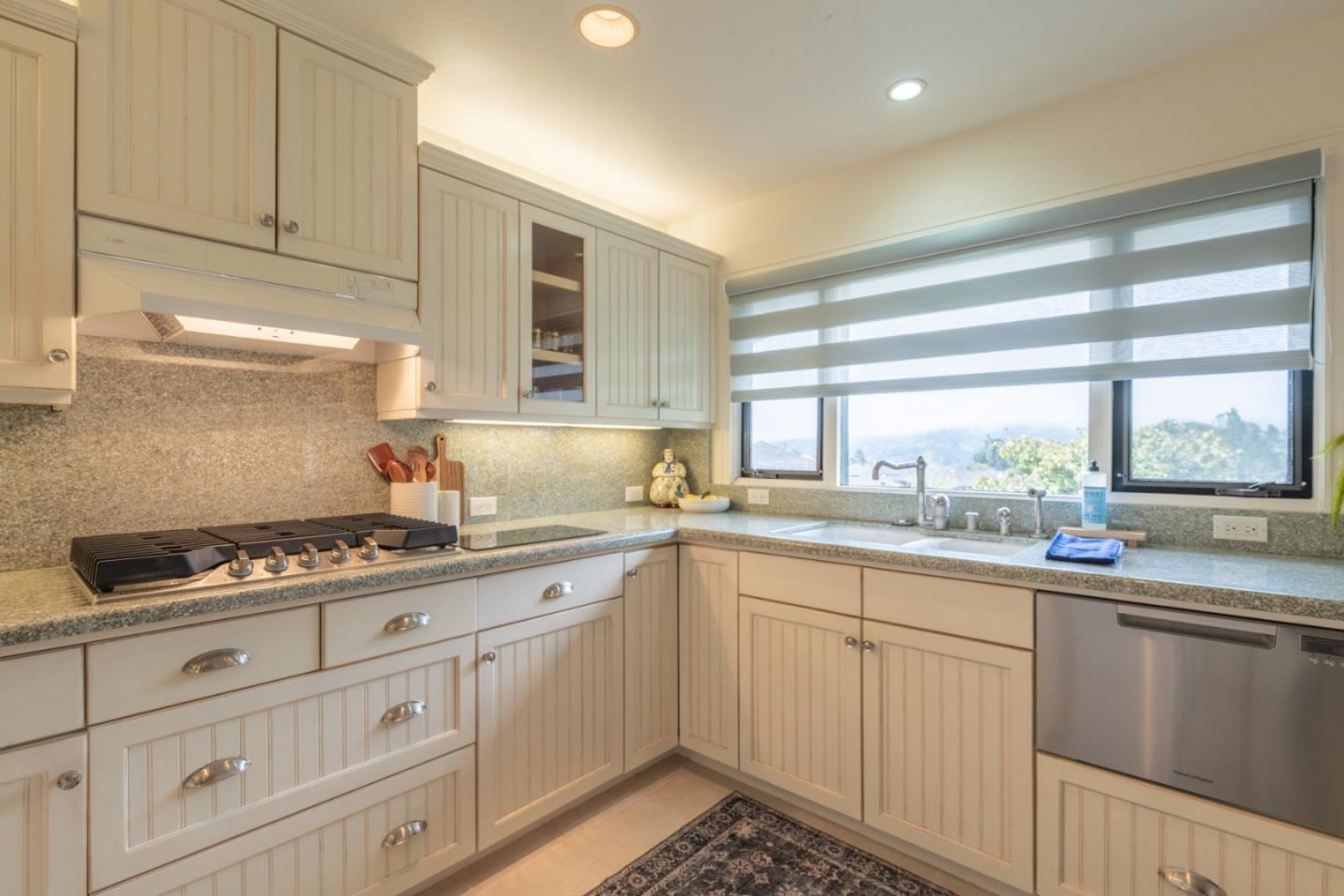 142 Del Mesa Carmel Carmel, CA 93923 - Photo 8 of 39 a kitchen with granite countertop a sink stove and cabinets