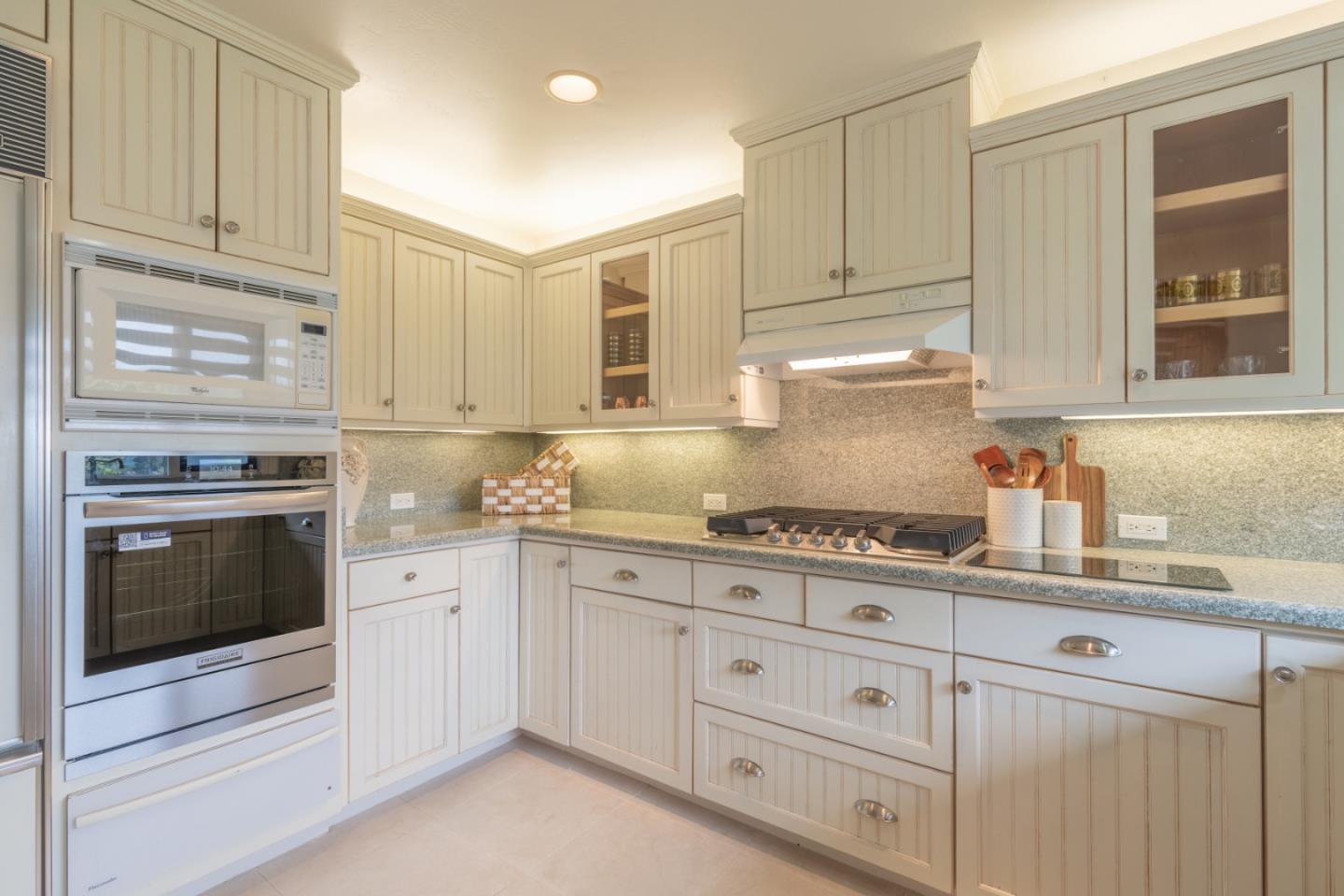 142 Del Mesa Carmel Carmel, CA 93923 - Photo 9 of 39 a kitchen with granite countertop white cabinets and stainless steel appliances